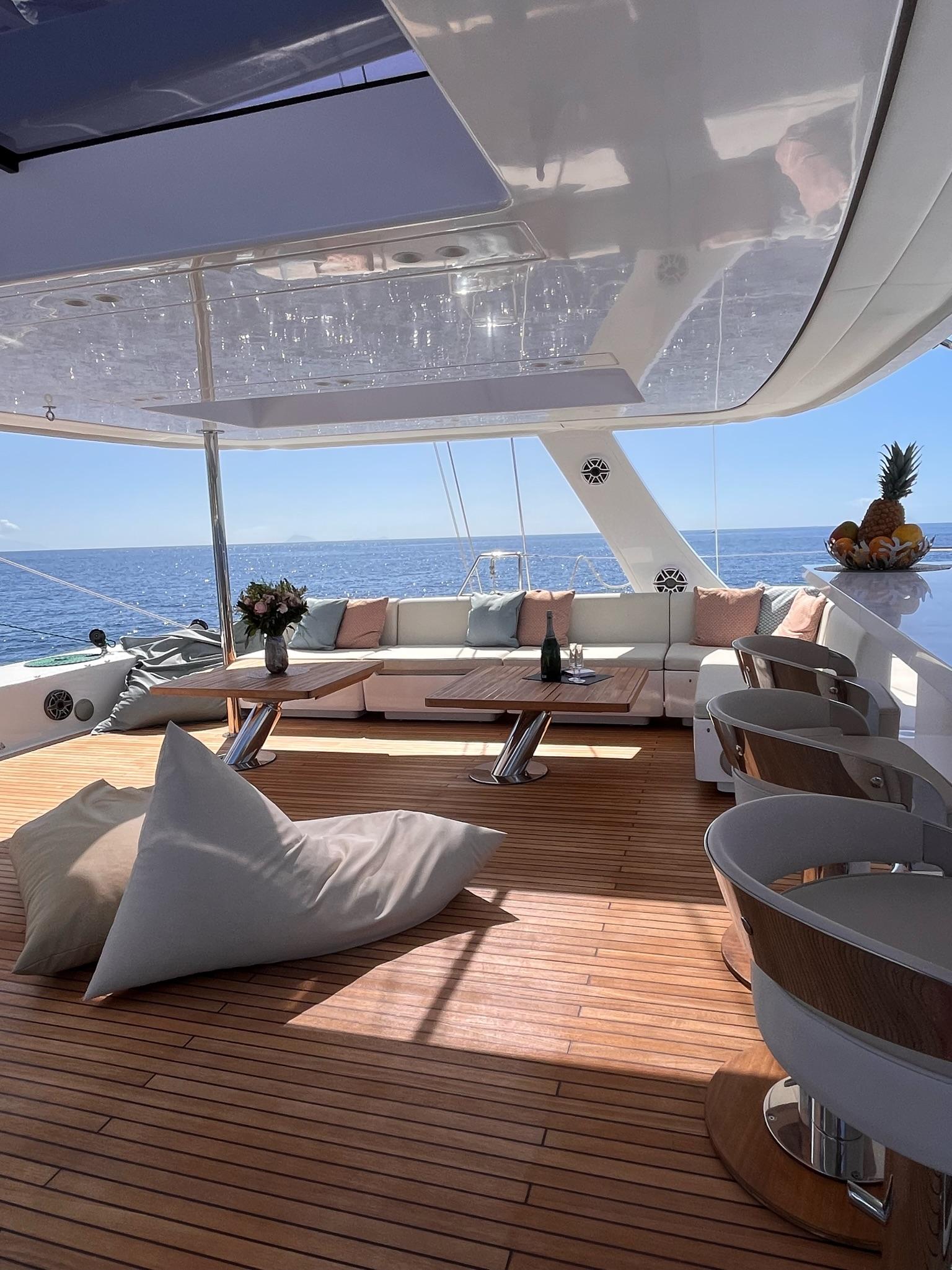 Outdoor flybridge dining and relaxation area on Sunreef 70+