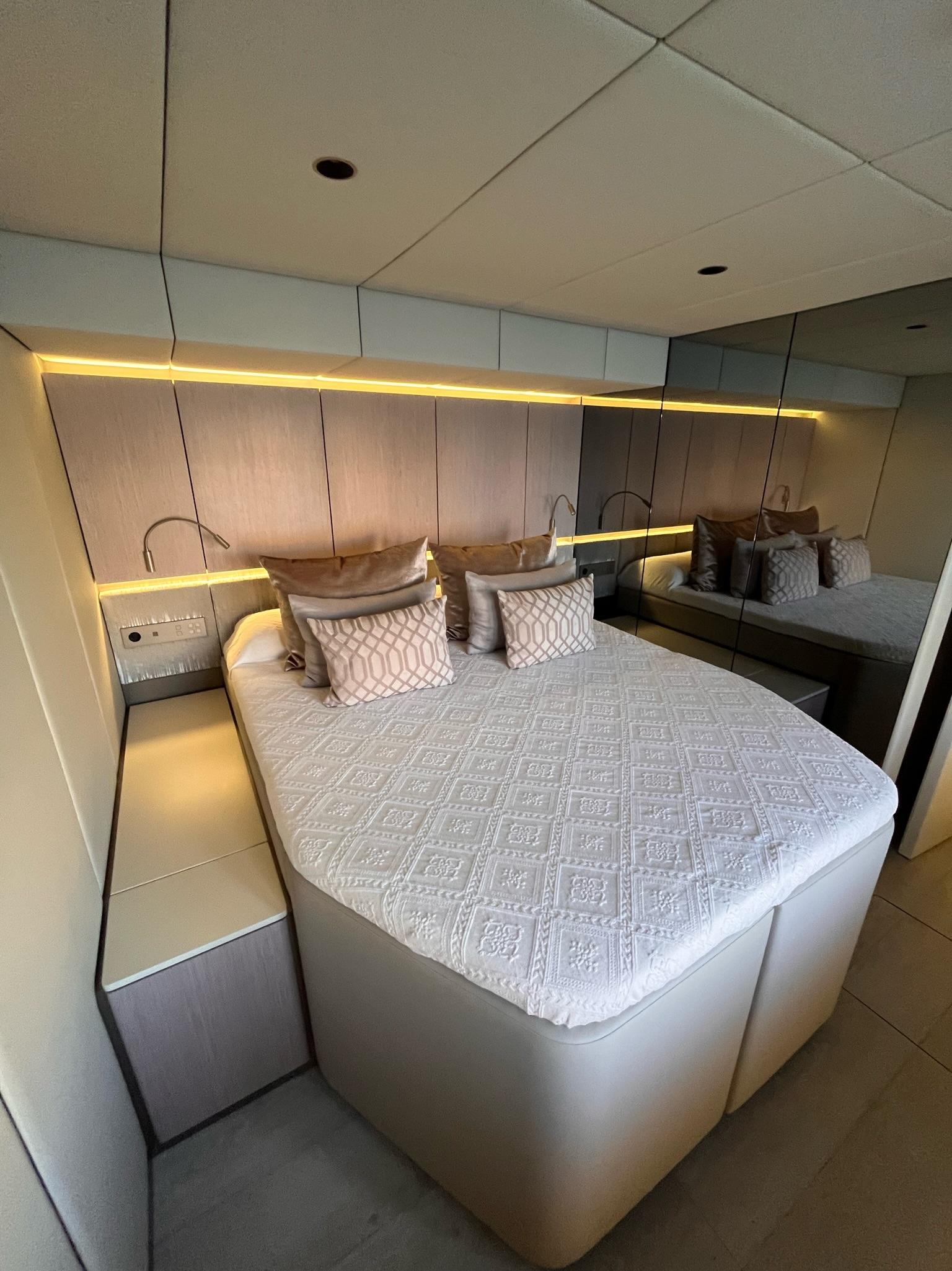 Contemporary twin bedroom with ambient lighting aboard Sunreef 70+