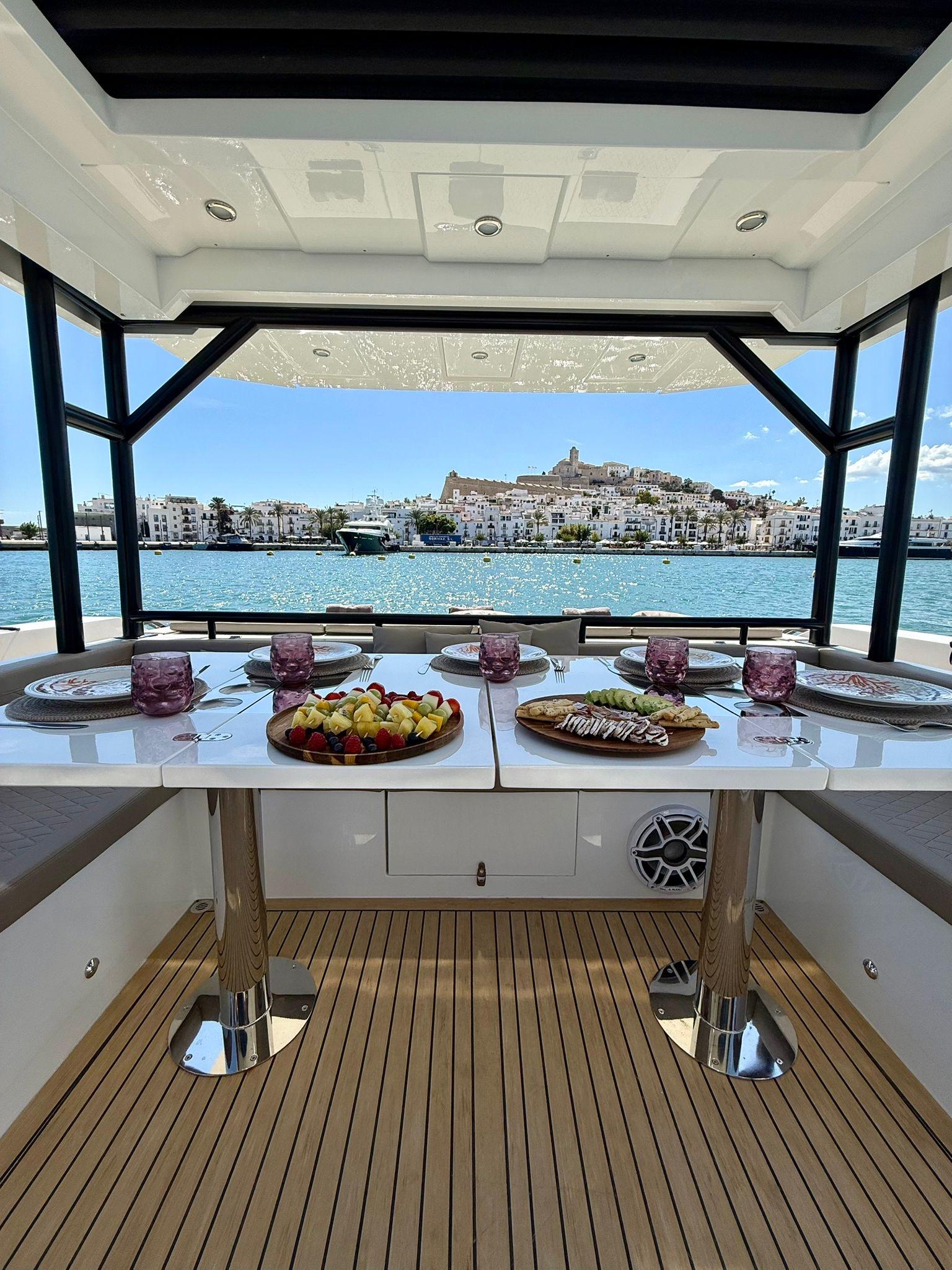 Private dining setup on De Antonio 50 Coupé yacht in Ibiza