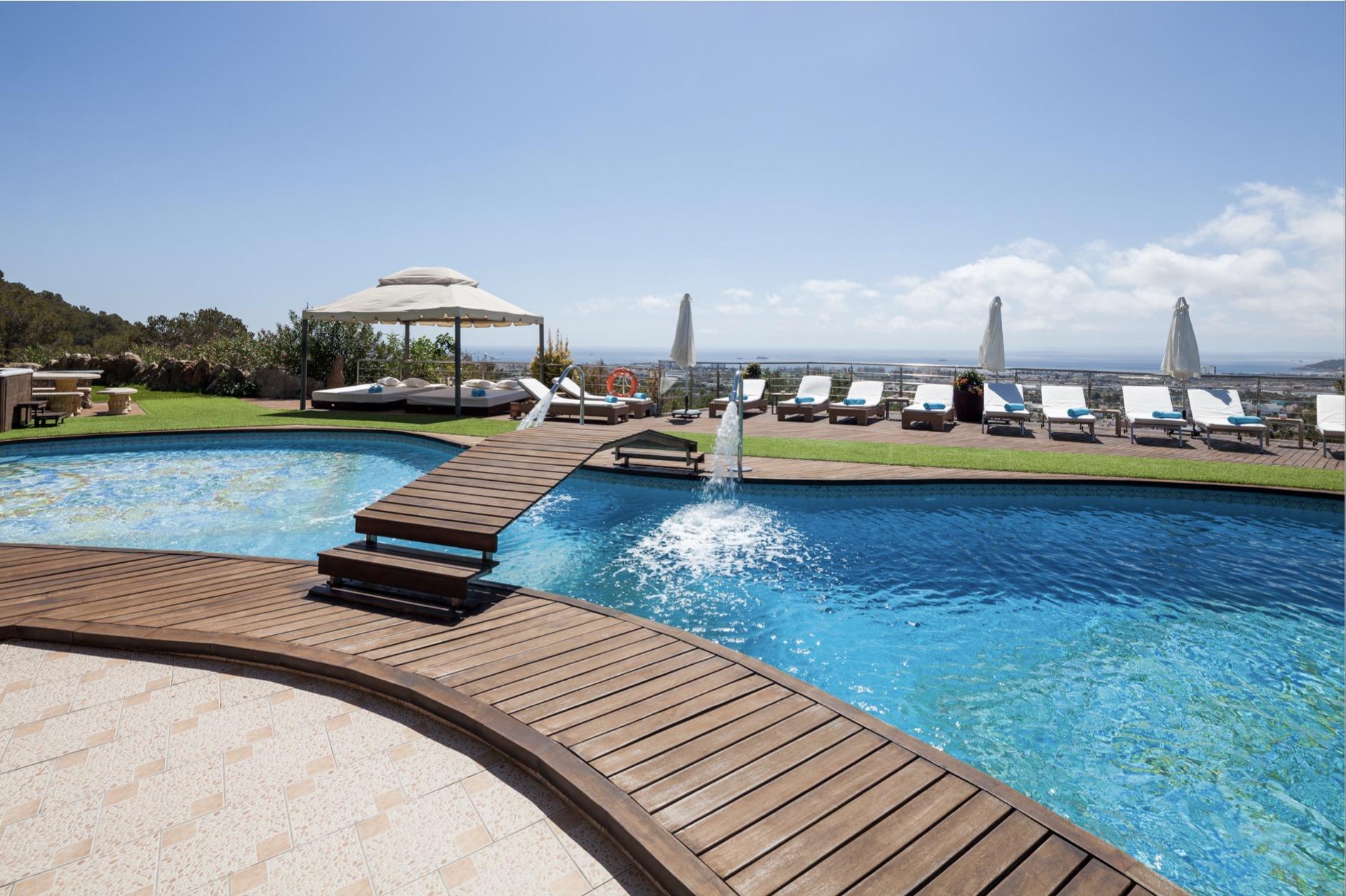 Private pool deck with sun loungers and sea views at Villa Tauranga