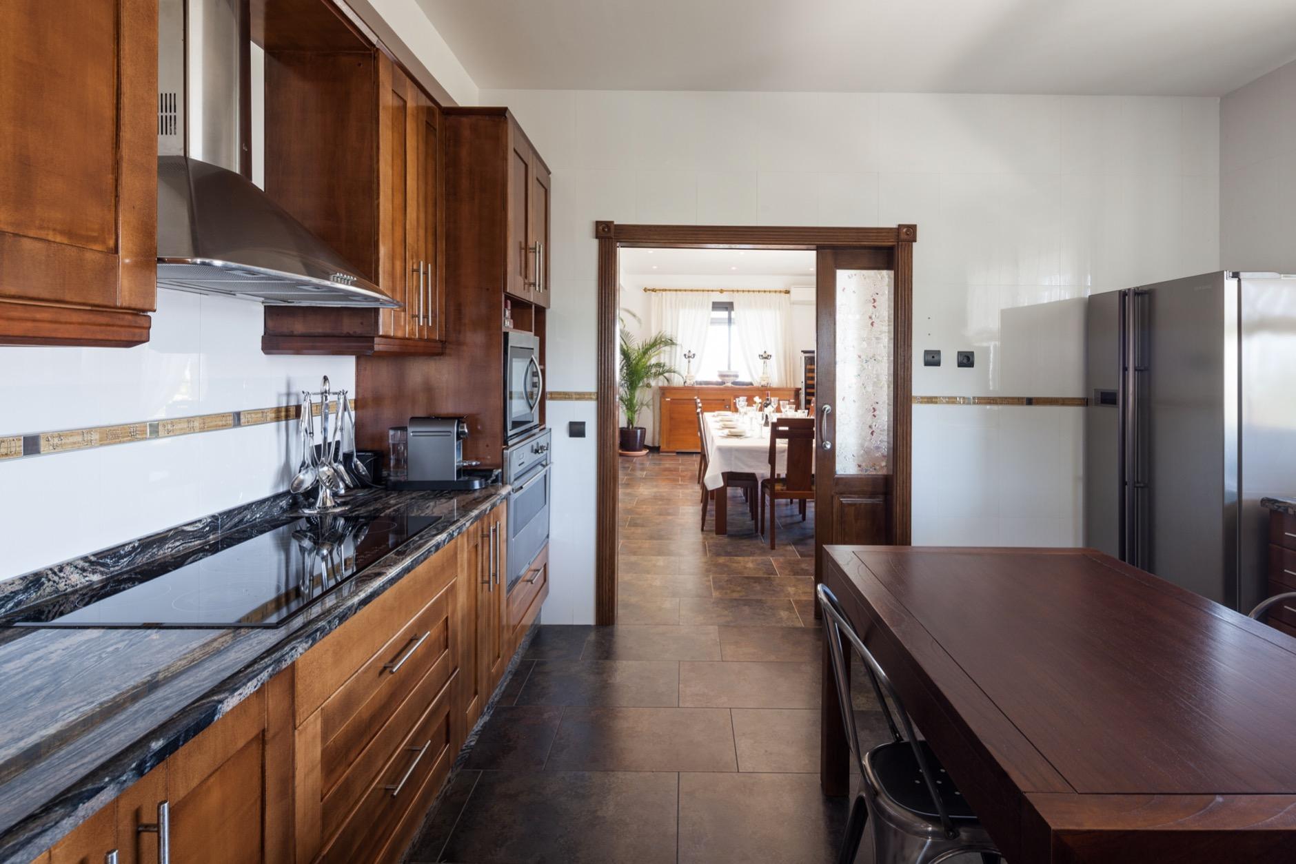 Designer kitchen with natural wood finishes and spacious open layout