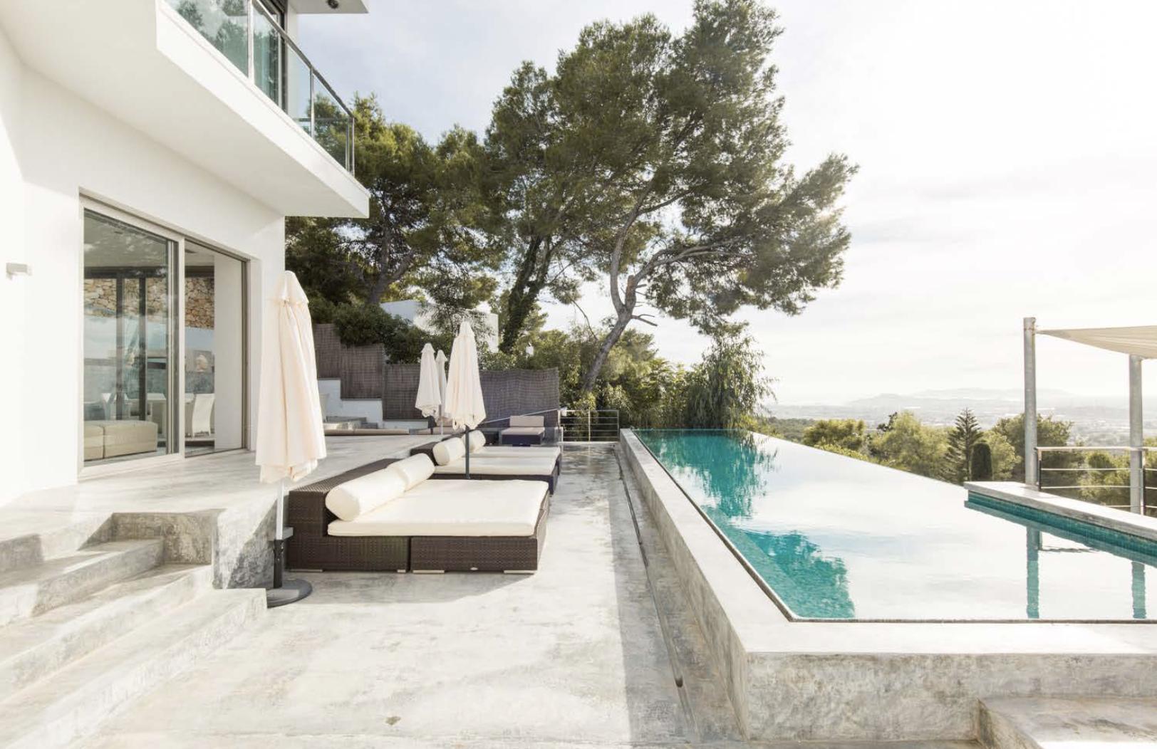 Modern infinity pool terrace surrounded by nature in Ibiza
