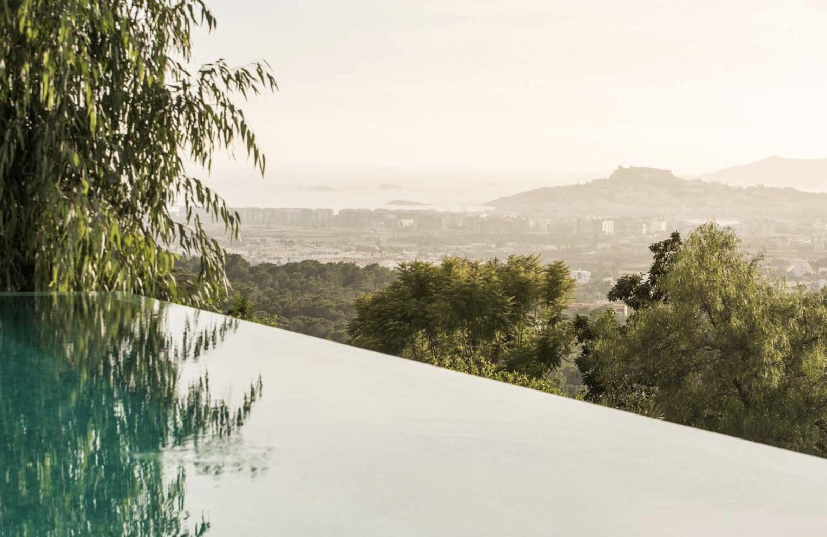 Infinity pool with Mediterranean landscape views at Villa Oradea