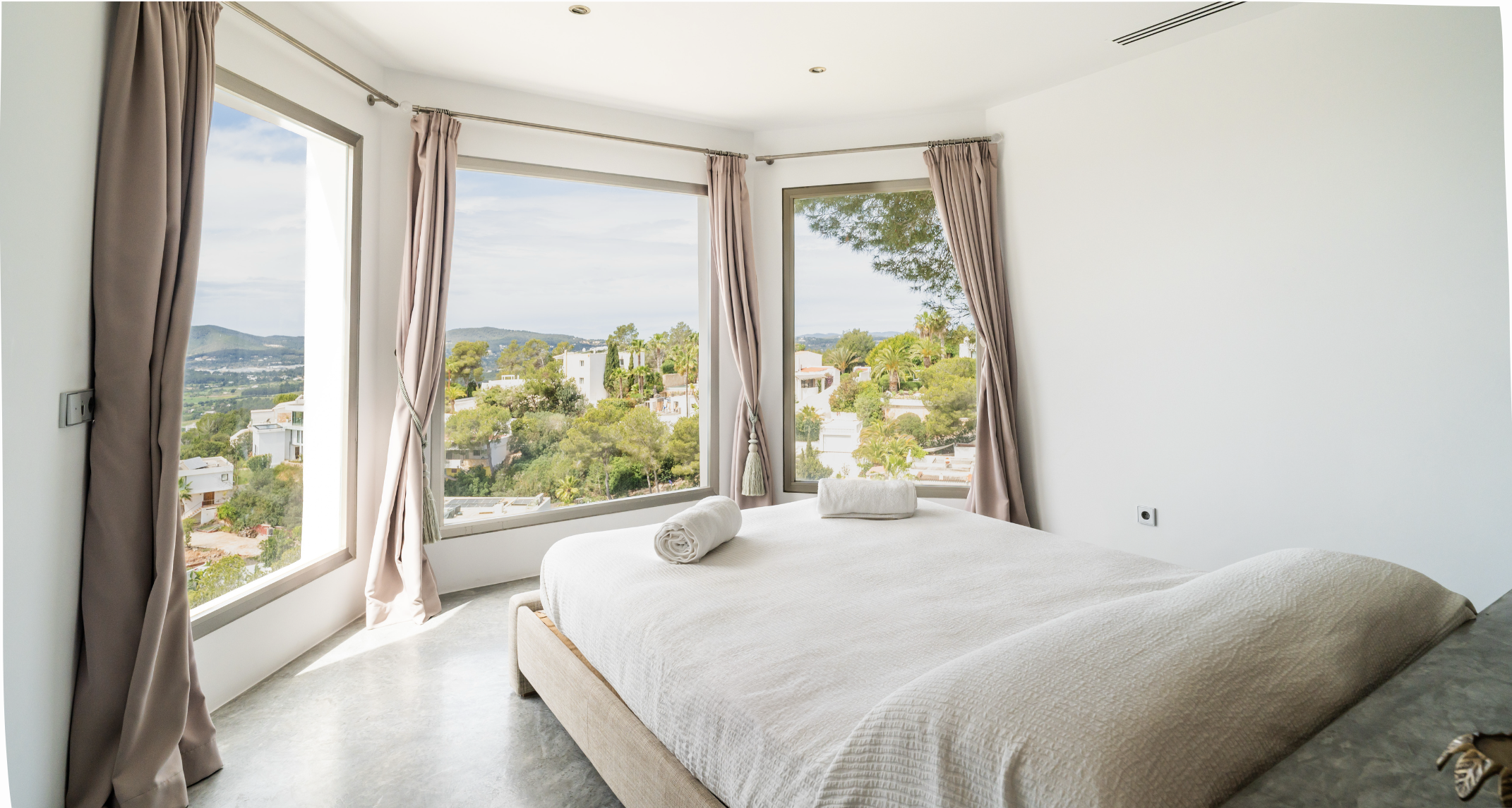 Elegant bedroom with panoramic Ibiza views at Villa Oradea