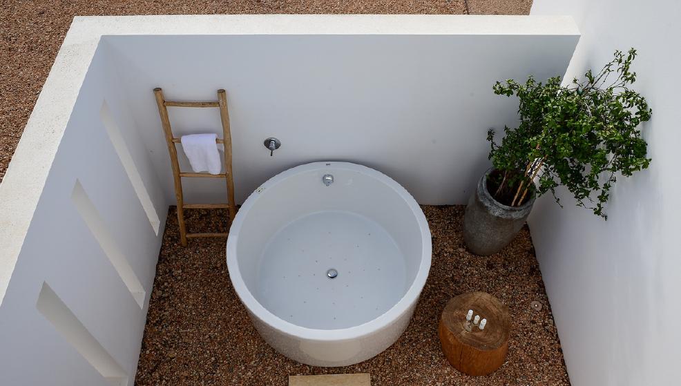 Minimalist outdoor bathtub in luxury Ibiza villa