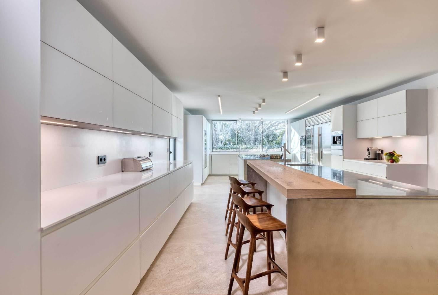 Minimalist white kitchen with premium appliances in Ibiza villa