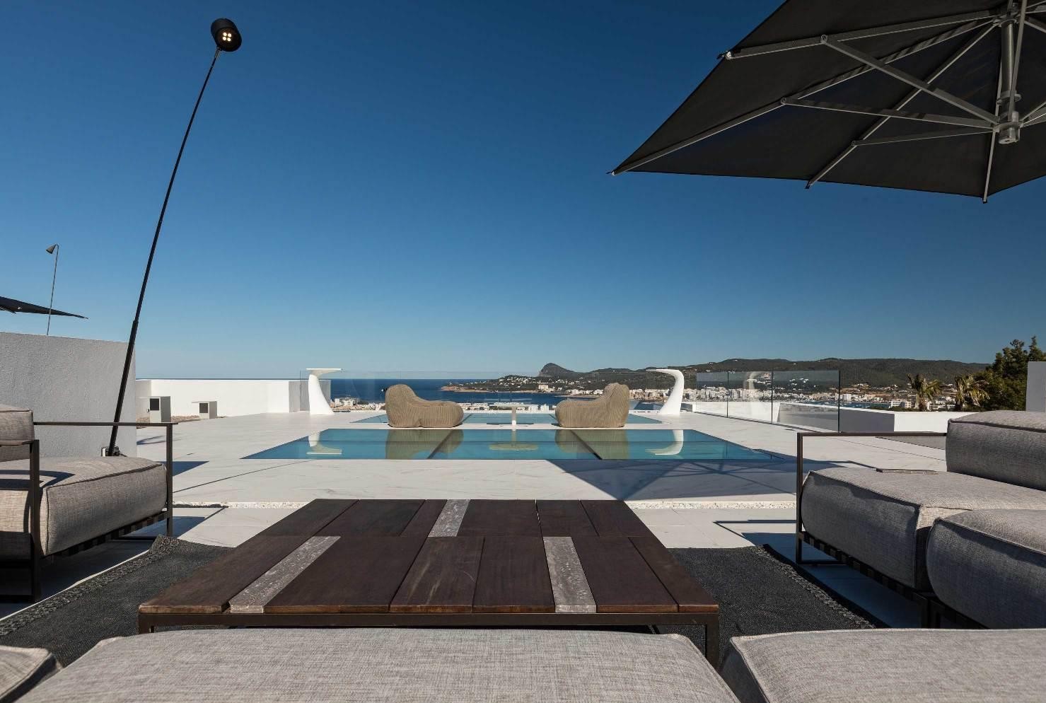 Outdoor lounge terrace with infinity pool and sea views