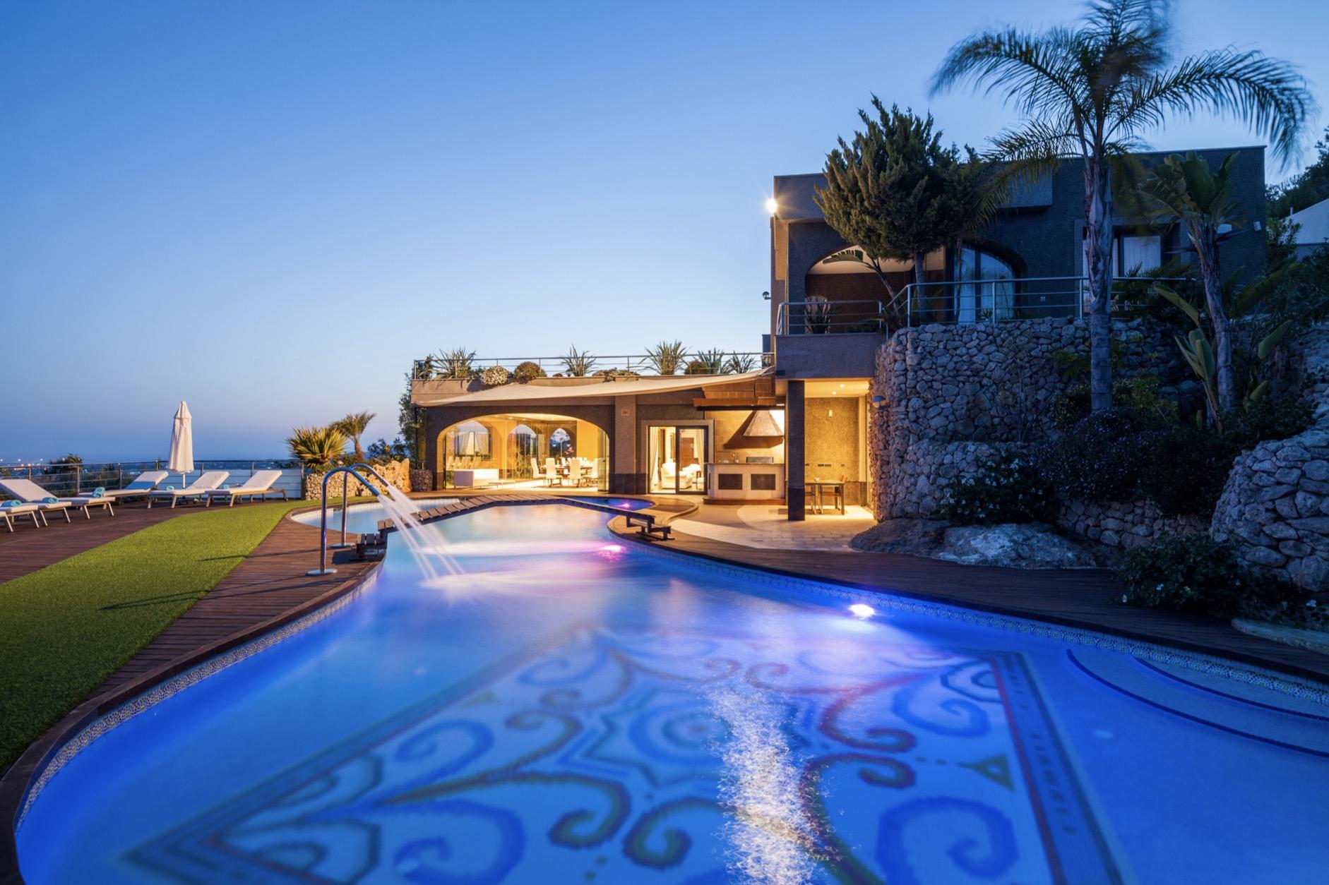 Private villa in Ibiza with illuminated pool at night