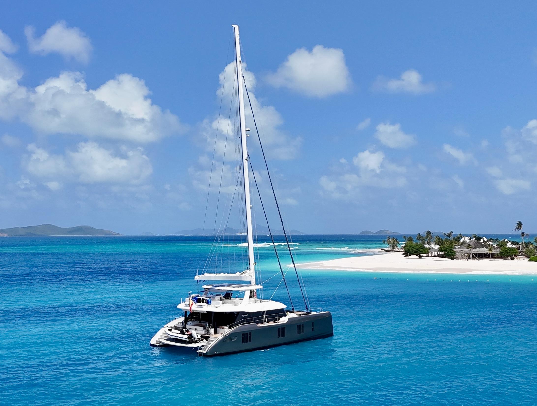 Sunreef 70+ luxury catamaran anchored in crystal-clear Mediterranean waters